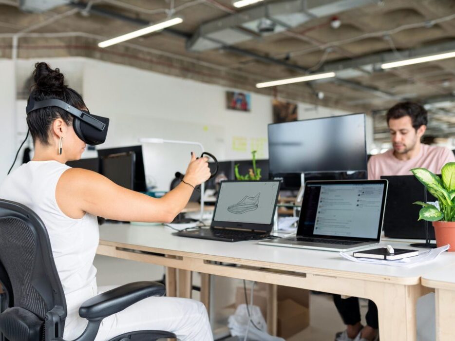 Woman using virtual reality headset in a modern office for design and innovation.